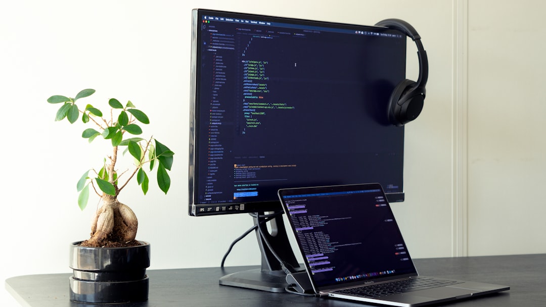 black flat screen computer monitor turned on beside black laptop computer